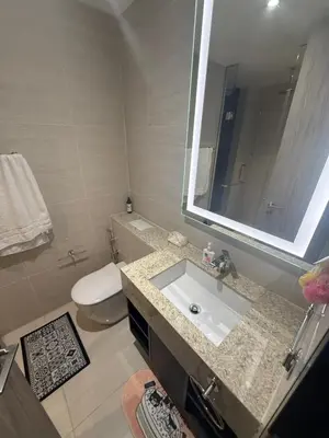 a bathroom with a sink and a toilet and a mirror at Star Residences KLCC by Nexus 3A in Kuala Lumpur