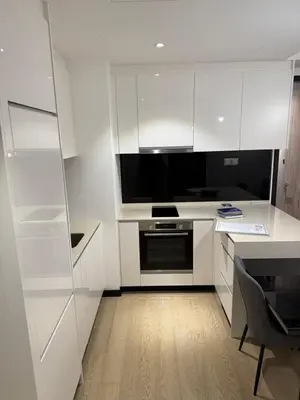 a kitchen with white cabinets and a black oven at Star Residences KLCC by Nexus 3A in Kuala Lumpur