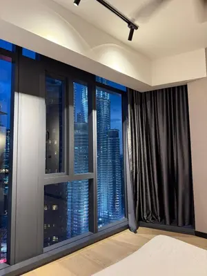 a bedroom with a view of a city skyline at Star Residences KLCC by Nexus 3A in Kuala Lumpur