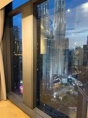 a view of a city skyline from a window at Star Residences KLCC by Nexus 3A in Kuala Lumpur