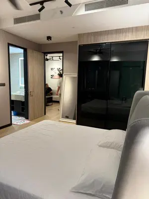 a bedroom with a large white bed in a room at Star Residences KLCC by Nexus 3A in Kuala Lumpur
