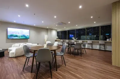a living room with tables and chairs and a couch at KAĨTE Suites at Wisma Cosway Sky Bridge to Pavilion KL in Kuala Lumpur