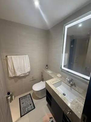 a bathroom with a sink and a toilet and a mirror at KL Star Residences KLCC By Nexus 38 in Kuala Lumpur