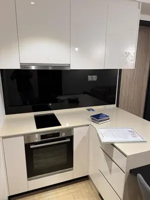 a kitchen with white cabinets and a stove at KL Star Residences KLCC By Nexus 38 in Kuala Lumpur