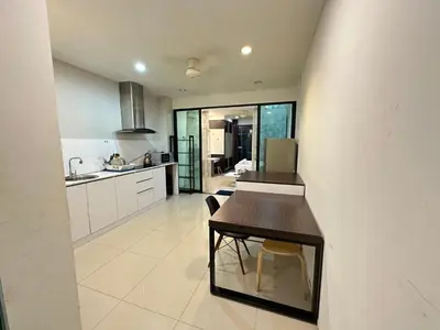 a kitchen with a wooden table and a counter at Taragon Luxury Suites Bukit Bintang,Kuala Lumpur in Kuala Lumpur