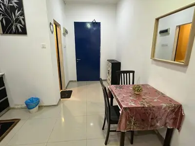 a dining room with a table and a blue door at Taragon Luxury Suites Bukit Bintang,Kuala Lumpur in Kuala Lumpur