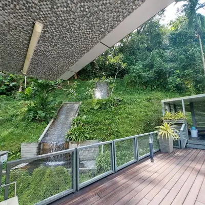 an outdoor deck with a view of a garden at Damas Plaza-Hartamas in Kuala Lumpur