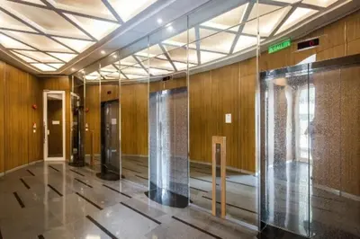 a hallway with glass doors in a building at KLCC View Penthouse in Kuala Lumpur