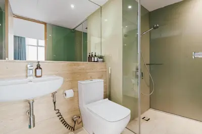a bathroom with a toilet and a sink and a shower at KLCC View Penthouse in Kuala Lumpur