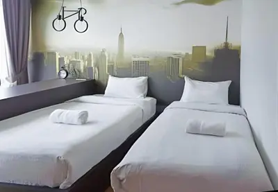 two beds in a room with a view of a city at KLCC View Penthouse in Kuala Lumpur