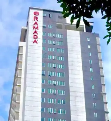 a tall building with a red sign on it at Crystal Suites at Ramad KLCC in Kuala Lumpur
