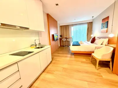 a kitchen and living room with a couch and a bed at Crystal Suites at Ramad KLCC in Kuala Lumpur