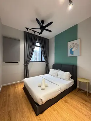a bedroom with a bed with a ceiling fan at Chambers Suites Kuala Lumpur by AFA in Kuala Lumpur