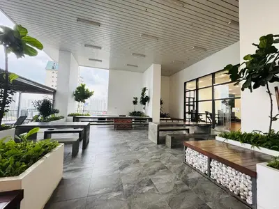 a lobby with benches and potted plants in a building at Chambers Suites Kuala Lumpur by AFA in Kuala Lumpur
