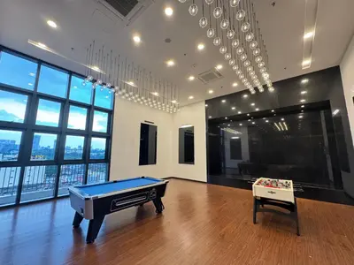 a room with a pool table in a room with windows at Chambers Suites Kuala Lumpur by AFA in Kuala Lumpur