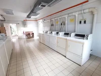 a large room with white washing machines in a kitchen at Seri Bukit Ceylon in Kuala Lumpur