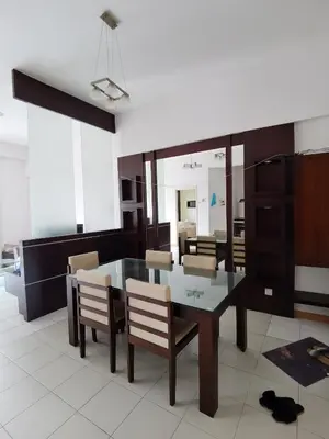 a dining room with a glass table and chairs at Seri Bukit Ceylon in Kuala Lumpur