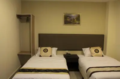 a hotel room with two beds and a picture on the wall at SohoTown Hotel in Kuala Lumpur