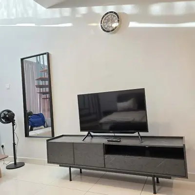 a living room with a flat screen tv on a table at 3 Tower Ampang Suite in Kuala Lumpur