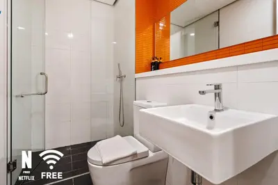 a bathroom with a sink and a toilet and a mirror at Arcoris Mont Kiara 3 min to 163mall 2 Bed in Kuala Lumpur