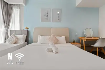 a bedroom with a large white bed and a desk at Mont Kiara Ooak Suite Sunway 163 with Bathtub 2 Bed in Kuala Lumpur