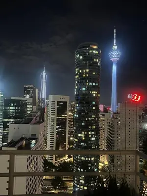 a view of a city at night with the space needle at Parkview One Bedroom & Two Bedroom apartment klcc in Kuala Lumpur
