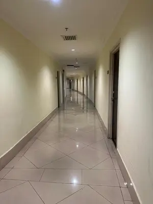 an empty hallway with white walls and a tile floor at Parkview One Bedroom & Two Bedroom apartment klcc in Kuala Lumpur