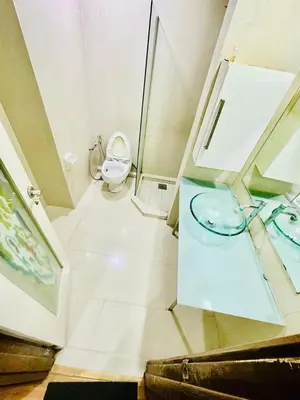 a white bathroom with a toilet and a sink at Parkview One Bedroom & Two Bedroom apartment klcc in Kuala Lumpur