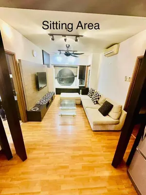 a living room with a couch and a tv at Parkview One Bedroom & Two Bedroom apartment klcc in Kuala Lumpur