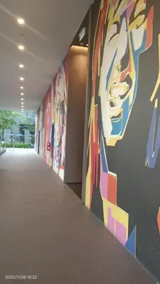 a hallway with colorful paintings on the walls of a building at Star klcc by AR Accommodation in Kuala Lumpur