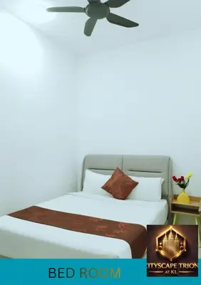 a bedroom with a bed with a ceiling fan at Cityscape Retreat TRION KL Premium Suites in Kuala Lumpur