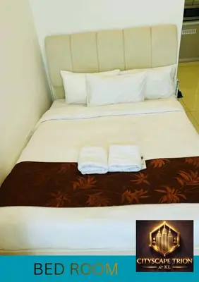 a bed with two white pillows on top of it at Cityscape Retreat TRION KL Premium Suites in Kuala Lumpur