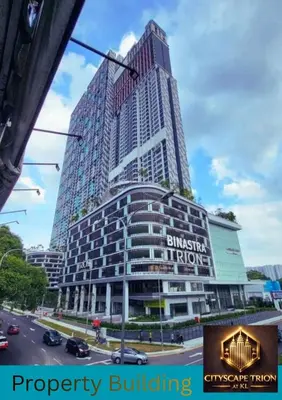 a tall building with a sign on the side of it at Cityscape Retreat TRION KL Premium Suites in Kuala Lumpur