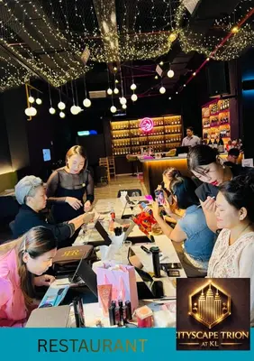 a group of people sitting around a table in a store at Cityscape Retreat TRION KL Premium Suites in Kuala Lumpur
