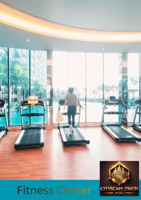 a woman walking on a treadmill in a fitness center at Cityscape Retreat TRION KL Premium Suites in Kuala Lumpur