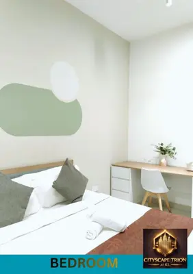 a bedroom with a bed with a desk and a chair at Cityscape Retreat TRION KL Premium Suites in Kuala Lumpur