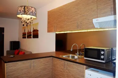 a kitchen with a sink and a microwave at Taragon Residences in Kuala Lumpur