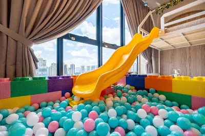 a play room with a pile of balls and a slide at Majestic Residence By Feel Home in Kuala Lumpur