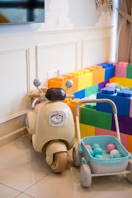 a toy scooter is parked next to a toy room at Majestic Residence By Feel Home in Kuala Lumpur