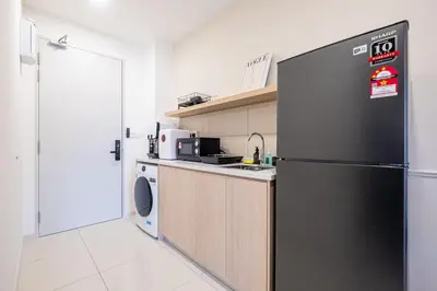 a kitchen with a black refrigerator and a dishwasher at Majestic Residence By Feel Home in Kuala Lumpur