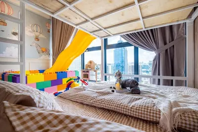 a bedroom with a large bed and a play area at Majestic Residence By Feel Home in Kuala Lumpur