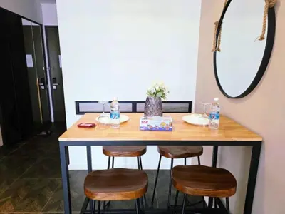 a table with four chairs and a mirror at Scarletz KLCC By AR Hospitality in Kuala Lumpur