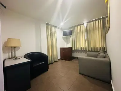 a room with a couch and a chair and a table at J Hotel Bukit Bintang in Kuala Lumpur