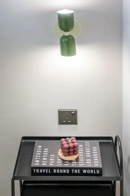 a plate of donuts on a table with a light at NOVO Ampang Modern Studio Infinity Pool near KLCC & Gleneagles in Kuala Lumpur