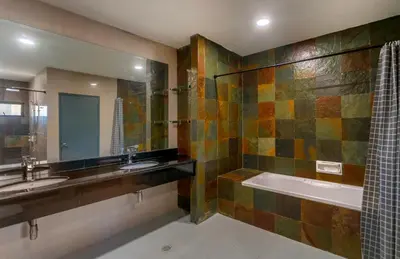 a bathroom with two sinks and a tub and a shower at Embassy Villa by COBNB, Top Floor Unit at Ampang Hilir in Kuala Lumpur