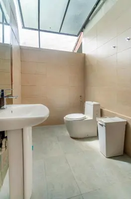 a bathroom with a toilet and a sink at Embassy Villa by COBNB, Top Floor Unit at Ampang Hilir in Kuala Lumpur