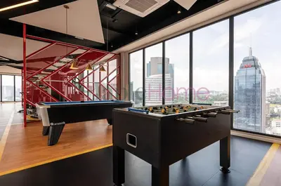 a billiard room with a view of the city at Majestic Residence Premier Suites Kuala Lumpur in Kuala Lumpur
