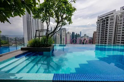 a swimming pool with a tree on top of a building at Majestic Residence Premier Suites Kuala Lumpur in Kuala Lumpur