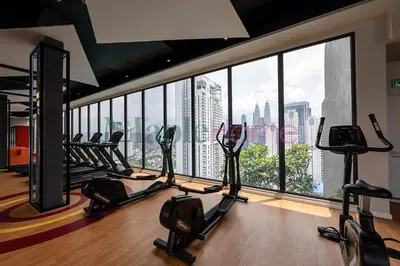 a gym with a view of a city skyline at Majestic Residence Premier Suites Kuala Lumpur in Kuala Lumpur