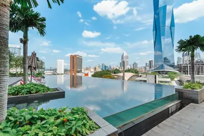 a swimming pool with a city skyline in the background at Blueground Kuala Lumpur pool nr Lake Gardens KUL-1 in Kuala Lumpur